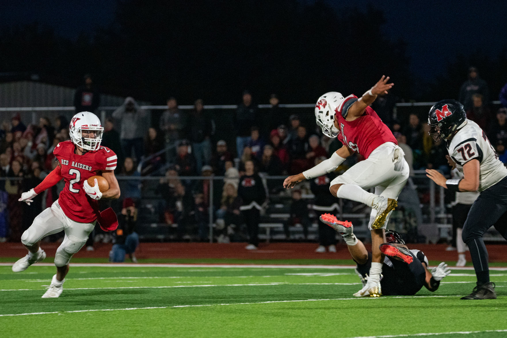 Taybor Vetter runs the ball white Brad Sackrider blocks